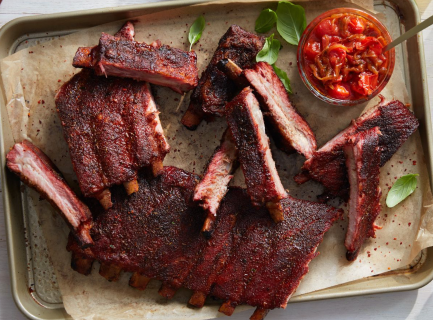 St. Louis-Style Ribs on a baking sheet with a chunky side sauce