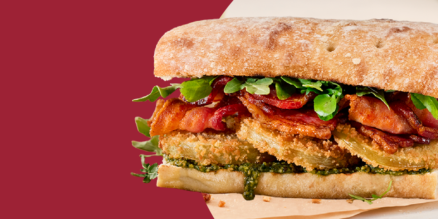 Fried green tomatoes and bacon sandwich on ciabatta bread.
