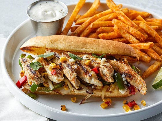 A Fajita Chicken Cheesesteak Sandwich featuring Tyson Red Label® Fajita Seasoned Chicken Breast Strips